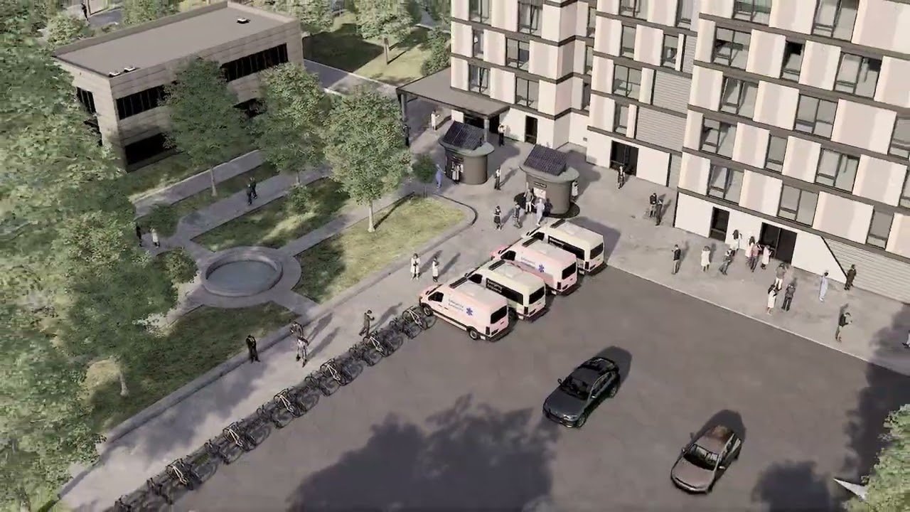 Vue aérienne de synthèse du village Wakinda : bâtiments, place centrale et allées plantées.